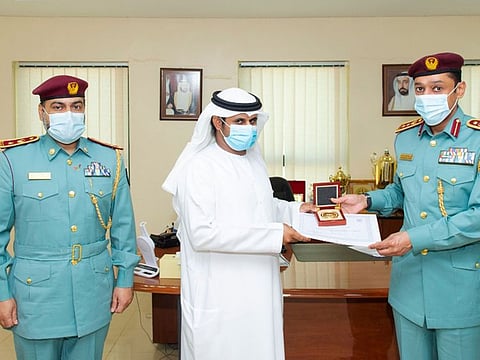 Salem Saeed Hammoud Al Deri being felicitated by Colonel Dr Ali Al-Kai Al-Hamoudi. Lieutenant Colonel Dr Walid Khamis Al Yamahi was also present at the felicitation.