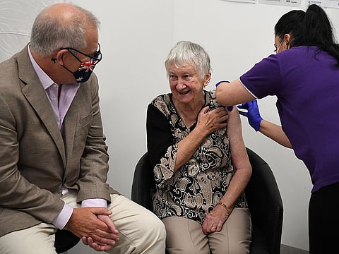 Australian Prime Minister Scott Morrison (left) joins aged care resident Jane Malysiak as she receives the first COVID-19 vaccine in Australia during a visit to Castle Hill Medical Centre to preview the COVID-19 vaccination program on Sunday, on February 21, 2021.