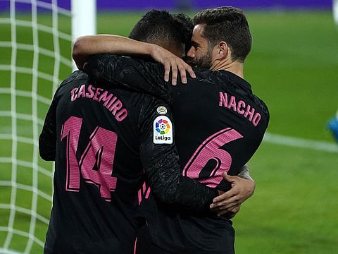 Real Madrid midfielder Casemiro celebrates with Nacho Fernandez after scoring against Real Valladolid