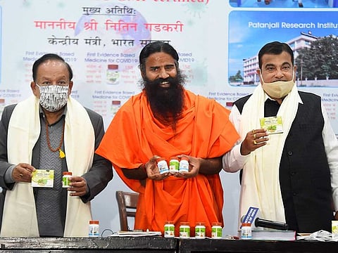 Baba Ramdev releases Patanjali medicine for COVID-19, in the presence of Union Ministers Nitin Gadkari  and Dr. Harsh Vardhan, during a press conference in New Delhi, Friday, Feb. 19, 2021.