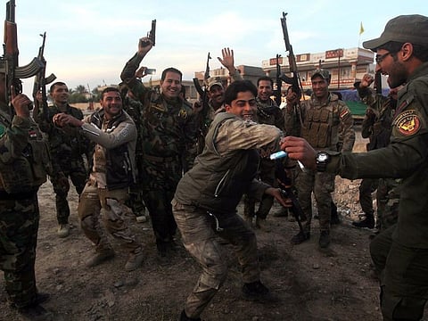 Shiite militia fighters of the Badr Organisation celebrating in Diyala Province after defeating Daesh militants. Founded by Mohammed Baqr Al Hakim in 1982, Badr Organisation first existed under the name the Badr Brigade as a major Iran-allied opposition group to the regime of Saddam Hussein.
