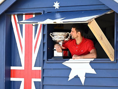 The Day After: Novak Djokovic with the Australian Open trophy, his ninth, at Brighton Beach in Melbourne last month.