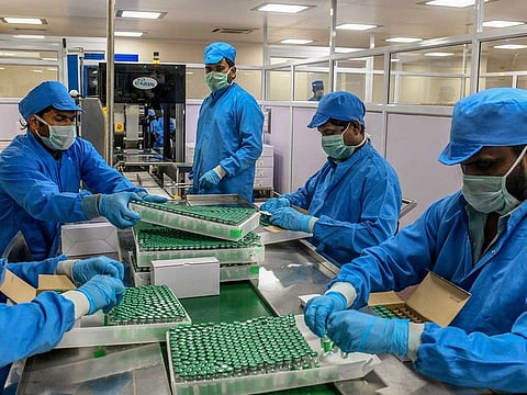 Workers packing the Covishield coronavirus vaccine at the Serum Institute of India in Pune, Jan. 14, 2021.
