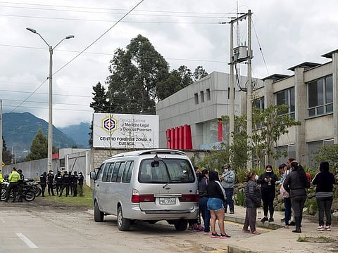 Family members stand outside the offices of the Forensic Medicine and Forensic Science institute after the bodies of several inmates, who died after a riot broke out at a local prison, were brought in, in Cuenca, Ecuador February 23, 2021.
