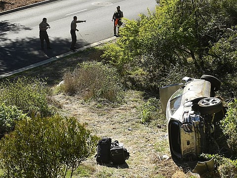 LA County officers survey the Tiger Woods car crash scene