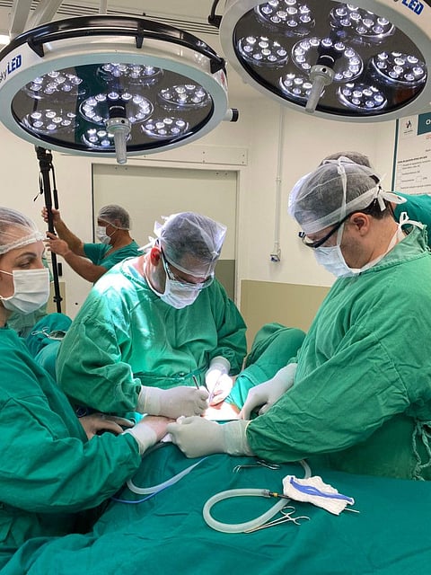 This handout picture released by the Transgender Centre Brazil shows the Brazilian doctor Jose Martins and his medical team from the Transgender Centre Brazil performing a sex reassignment surgery on the 19-year-old Brazilian twins Sofia Albuquerck and Mayla Rezende, in Blumenau, Brazil, on February 11, 2021.