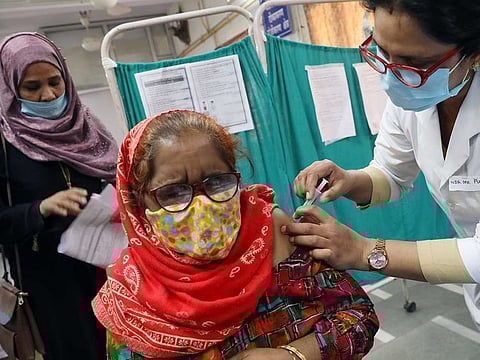 A frontline worker receives Bharat Biotech's COVID-19 vaccine called COVAXIN, at Hindu Rao Hospital, in New Delhi, India on Tuesday, February 23, 2021.