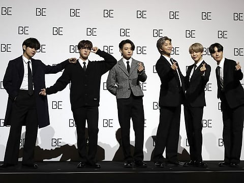 Members of South Korean band BTS pose for photographers during a press conference to introduce their new album "BE" in Seoul, South Korea, Friday, Nov. 20, 2020.