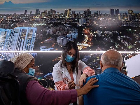 In this Monday, Jan. 25, 2021 file photo, an Israeli man receives the second dose of the Pfizer-BioNTech COVID-19 vaccine at a coronavirus vaccination center in Tel Aviv, Israel.