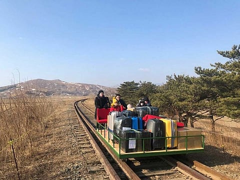 Russian diplomats and family members leave North Korea to Russia using a hand-pushed rail trolley due to Pyongyang's coronavirus restrictions on February 25, 2021.