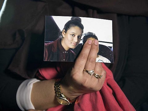 In this file photo taken on February 22, 2015 Renu, eldest sister of missing British girl Shamima Begum, holds a picture of her sister while being interviewed by the media in central London.