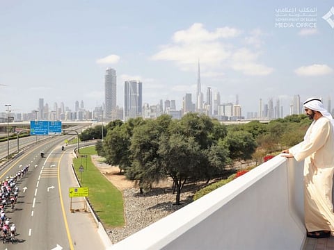 His Highness Sheikh Mohammed bin Rashid Al Maktoum greets cyclists on UAE Tour
