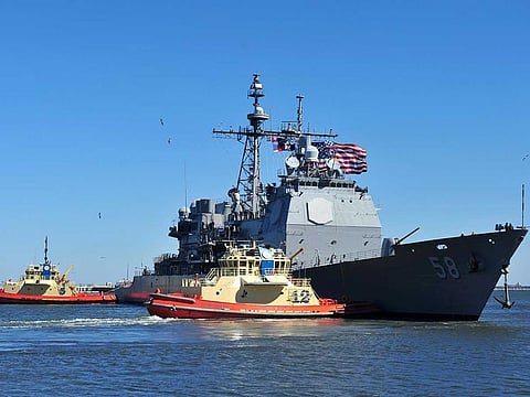 In this Feb. 15, 2014, photo released by the US Navy, the guided-missile cruiser USS Philippine Sea leaves Naval Station Mayport in Mayport, Florida. Two US Navy warships operating in the Mideast have been affected by the coronavirus, authorities said Friday, Feb. 26, 2021, with one already at port in Bahrain and another heading to port.