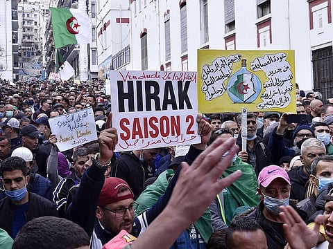 Algerian anti-government protesters take part in a demonstration in the capital Algiers, on February 26, 2021.