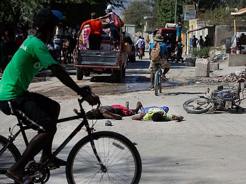 The bodies of two inmates lie on the street outside the Croix-des-Bouquets Civil Prison after an attempted breakout, in Port-au-Prince, Haiti.