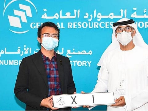 Xian Jun Xu receives his special number plate.