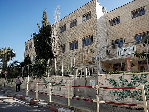A man walks past a closed school, amid the COVID-19 outbreak, in Ramallah, West Bank, on February 27, 2021.
