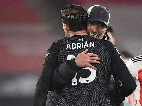 Liverpool manager Juergen Klopp celebrates with Adrian after the match.