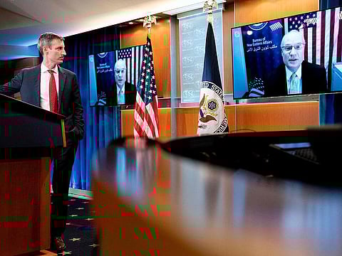 State Department spokesman Ned Price(L) listens as US special envoy for Yemen Timothy Lenderking speaks via teleconference during a news conference at the State Department in Washington, DC on February 16, 2021.