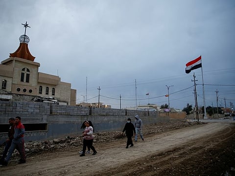 Iraqi Christian walk near a church in Qaraqosh, Iraq February 16, 2021.