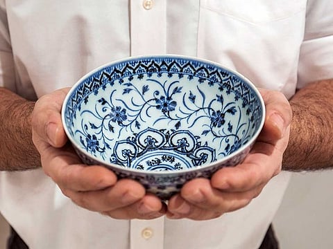 This photo, provided by Sotheby's, in New York, on Tuesday, March 2, 2021, shows a small porcelain bowl bought for $35 at a Connecticut yard sale that turned out to be a rare, 15th century Chinese artifact worth between $300,000 and $500,000. The bowl will be offered in Sotheby's Auction of Important Chinese Art, in New York, on March 17.