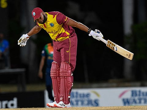 Kieron Pollard of West Indies takes a bow after hitting six sixes off Akila Dananjaya of Sri Lanka during their T20 win at Coolidge Cricket Ground in Osbourn, Antigua and Barbuda on Wednesday.
