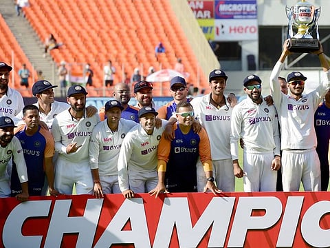 Indian team members with the winners' trophy after defeating England by an innings in the fourth and final Test to wrap up the series 3-1 in Ahmedabad on Saturday.