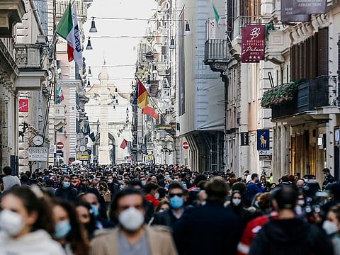 People crowd Via del Corso shopping street in Rome, following the ease of restriction measures to curb the spread of COVID-19.