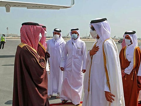 This handout picture provided by Qatar's Ministry of Foreign Affairs on March 8, 2021 shows Qatar's Foreign Minister Sheikh Mohammed bin Abdulrahman Al Thani (2nd-R) greeting Saudi Arabia's Foreign Minister Prince Faisal bin Farhan Al Saud upon arrival in Qatar.