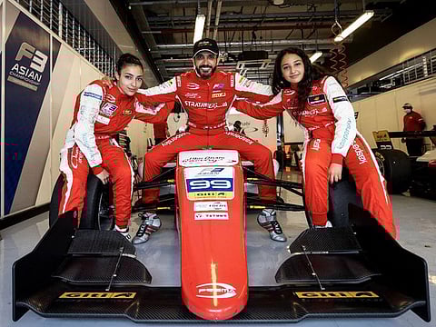 Khaled Al Qubaisi with his daughters Amna and Hamda