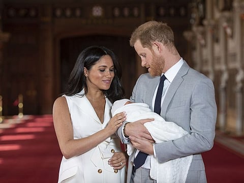 In this Wednesday May 8, 2019 file photo, Britain's Prince Harry and Meghan, Duchess of Sussex, pose during a photocall with their newborn son Archie, in St George's Hall at Windsor Castle, Windsor, south England.