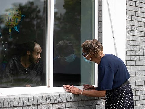 In this June 26, 2020, file photo Southern Pines nursing home resident Wayne Swint gets a birthday visit from his mother, Clemittee Swint, in Warner Robins, Georgia.