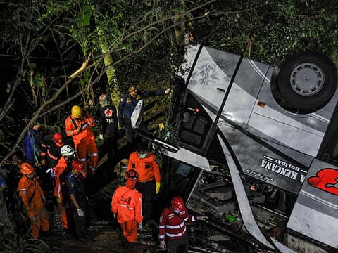 Rescue personnel work at the crash site after a bus fell into a ravine in Sumedang, West Java Province, Indonesia.