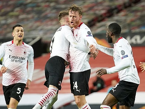 AC Milan's Simon Kjaer, centre, celebrates after scoring the equaliser against Manchester United.