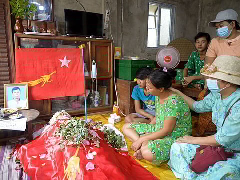 Relatives view the remains of Aung Aung Zaw as he lies in state at the family home in Yangon, Myanmar Saturday, March 13, 2021. Aung Aung Zaw was a 41-year old supporter of the National League for Democracy party who was shot after midnight Saturday while he was among a group of people outside a police station in Thar Kay Ta township in Yangon demanding that they release people who were arrested.