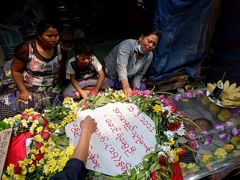 Family members cry near the coffin of Ye Swe Oo 20, who was shot and killed during the security crackdown on anti-coup protesters in Mandalay, Myanmar March 14, 2021.