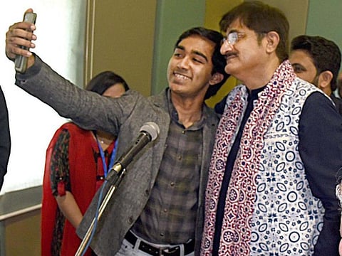 A member of the Karachi Vocational Training Centre takes a selfie with Sindh Chief Minister Syed Murad Ali Shah.