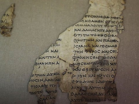 A recently-discovered scroll fragment of an ancient biblical text is seen at Israel Antiquities Authority laboratories in Jerusalem.