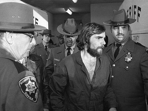 In this Nov. 15, 1974 file photo, Ronald DeFeo Jr., center, leaves Suffolk County district court after a hearing, on New York's Long Island.