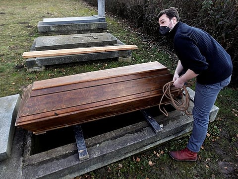 Actor Tomas Novotny secures an empty coffin at a training cemetery as a part of his re-qualification procedure amid the COVID-19 outbreak in Prague, Czech Republic.