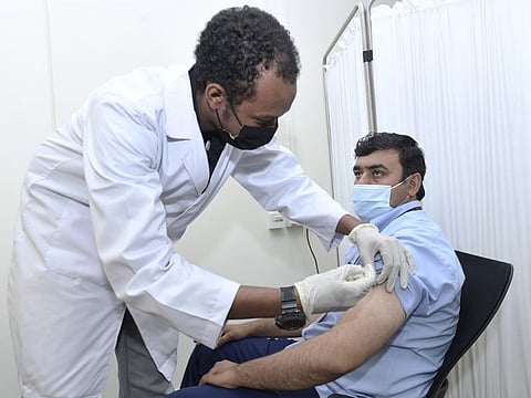 An RTA employee being vaccinated against COVID-19.