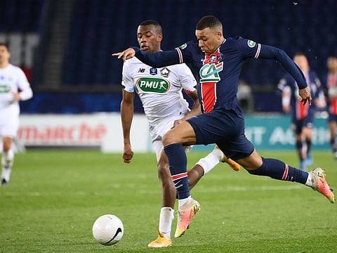 Kylian Mbappe of Paris St Germain (right) tears through the Lille defence during their French Cup encounter on Thursday.