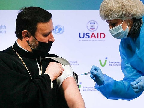 Ukrainian Orthodox Church priest Lavrenty receives a dose of the AstraZeneca COVID-19 vaccine marketed under the name CoviShield in Kyiv, Ukraine, Tuesday, March 16, 2021.