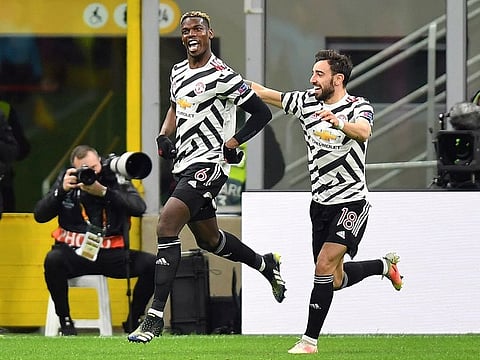 Manchester United's Paul Pogba celebrates scoring their first goal with Bruno Fernandes.
