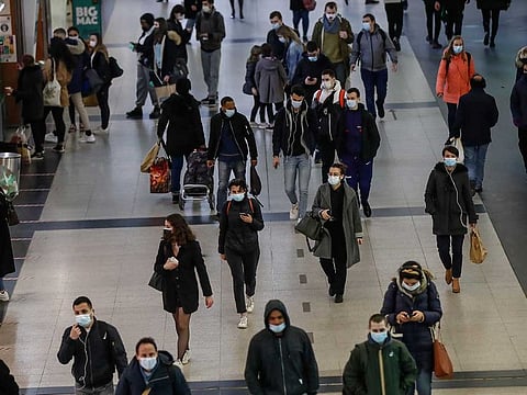 People wearing masks to prevent the spread of the coronavirus walk in a subway hub after work at la Defense business district in Paris, Thursday, March 18, 2021. French government announced Thursday a month-long lockdown for Paris and other regions of the country starting Friday.