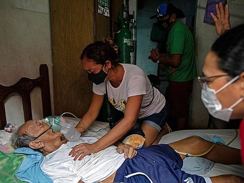 Relatives react as Jose Moreira, 90, passes away because of complications derived from COVID-19 at his home in Manaus, Brazil, on January 30, 2021. -