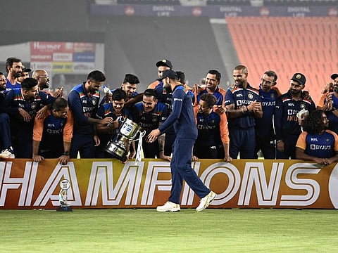 India captain Virat Kohli (centre) hands over the trophy to his teammates after winning the Twenty20 series against England at the Narendra Modi Stadium in Motera on Saturday.