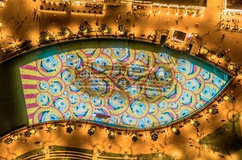 Underwater smileys mark International Happiness Day at Global Village.
