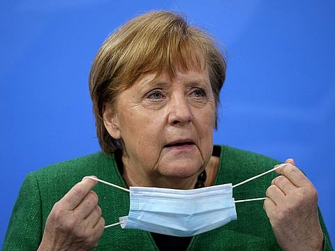 German Chancellor Angela Merkel holds a mask at a news conference after a meeting with state leaders to discuss options beyond the end of the pandemic lockdown, amid the outbreak of the coronavirus disease (COVID-19), in Berlin, Germany, March 23, 2021.