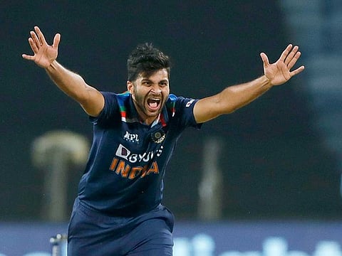 India’s Shardul Thakur celebrates the dismissal of England’s Eoin Morgan during the first ODI against England in Pune on March 23, 2021.